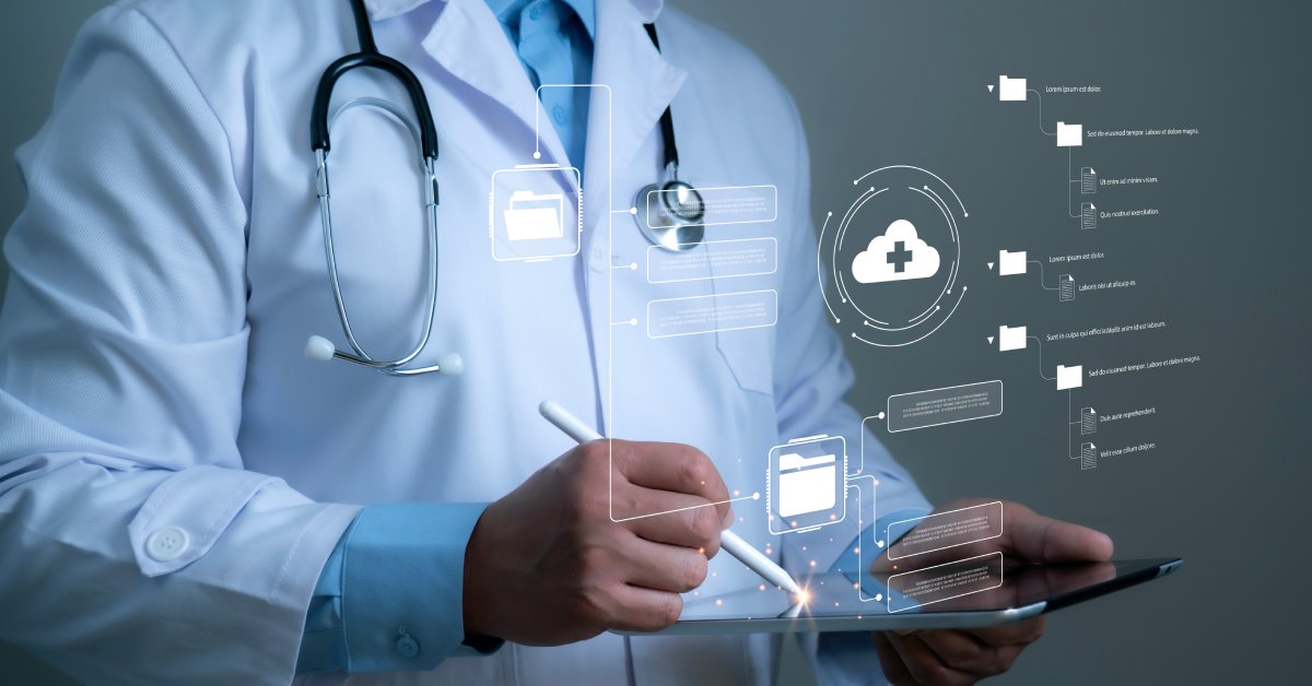 A close-up of a man wearing a doctor's coat and holding a tablet and digital pencil to navigate files.