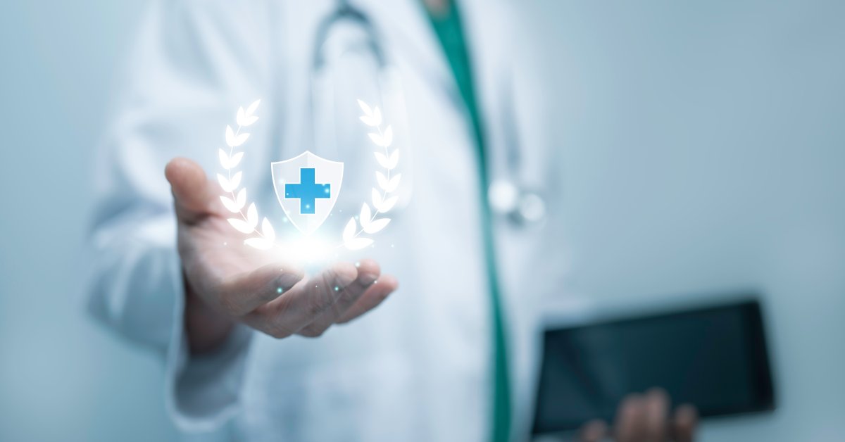 A person wearing a medical coat and stethoscope holds a tablet in one hand and an abstract medical award symbol in the other.